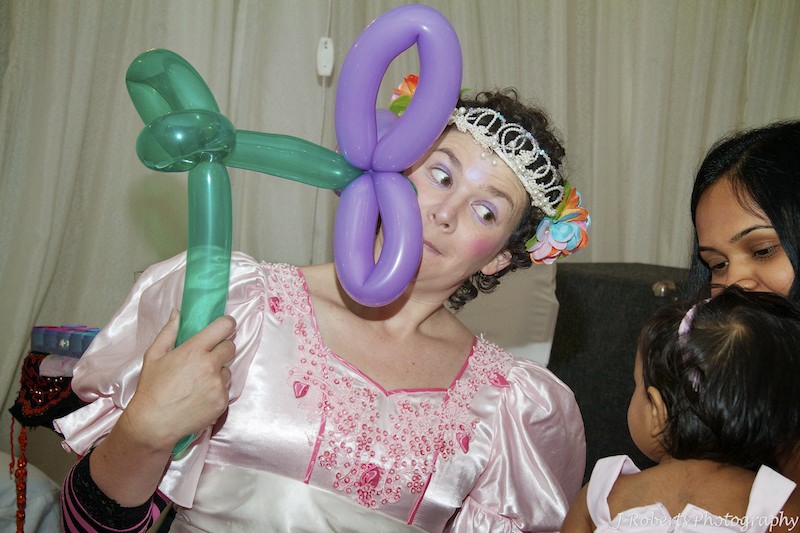 Fairy princess making balloon flower for little girl at first birthday party - party photography sydney